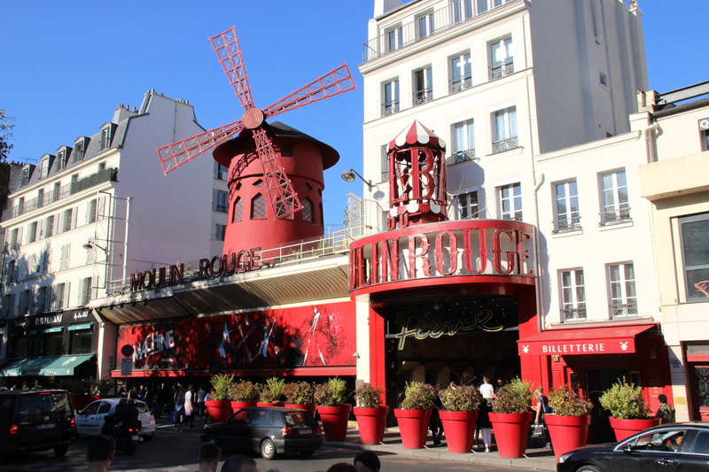 5K, architecture, street, outdoors, low angle view, group of people, moulin rouge, incidental people, city, communication, text, nature, real people, sky