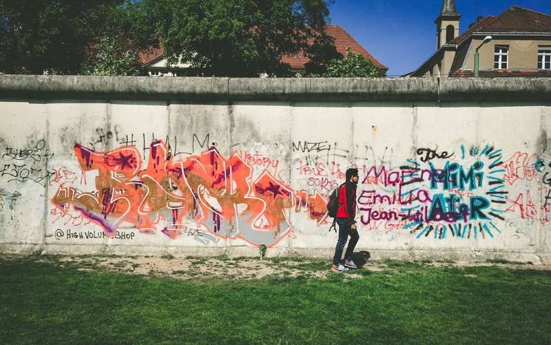 sports clothing, mural, multi colored, grass, wall - building feature, street art, full length, red, building exterior, architecture, stadium, graffiti
