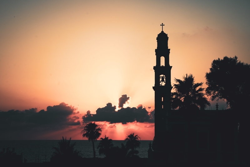 sun, tel aviv-yafo, copy space, sunset, outdoors, place of worship, clouds, church, israel, trees, building exterior, plant, belief, dusk, sea, beauty in nature