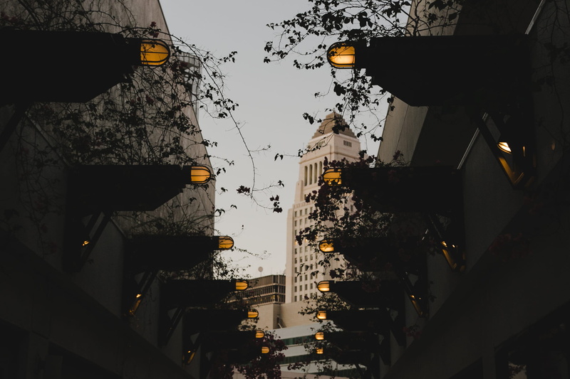 tall - high, sky, motor vehicle, symmetrical, plants, city life, building exterior, building, mode of transportation, lighting equipment, residential district