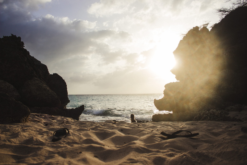 solid, horizon, flipflops, water, outdoors, beach, tranquil scene, no people, rock - object, scenics - nature, cloud - sky, sunlight, rock formation, summer