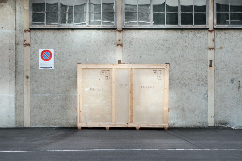 gray, heavy, crate, built structure, delicate, outdoors, breakable, beige, window, text, building, delivery, box, warning, architecture, sign, deliver