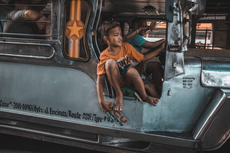 beside, philippines, jeepney, rail transportation, boy, puj, travel, driver, young adult, sitting, full length, one person, lifestyles, riding, street work