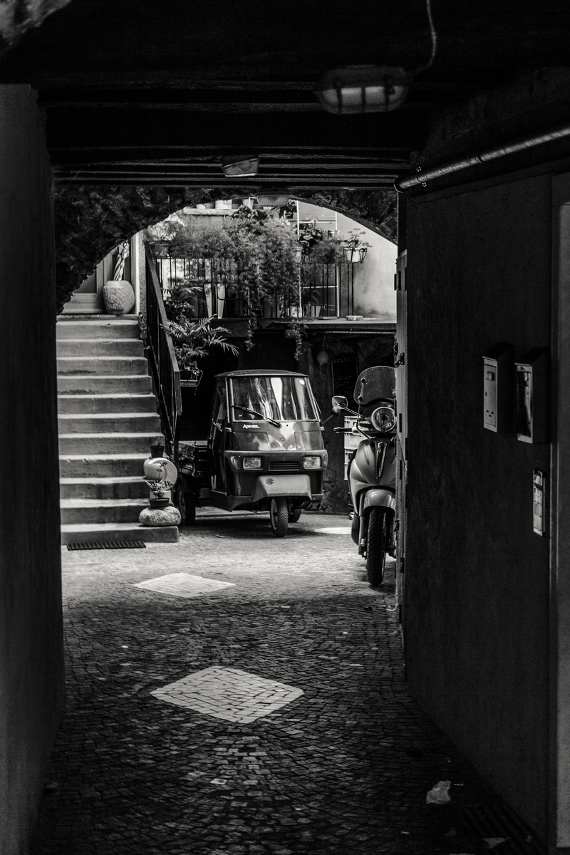 narrow lane, day, outdoors, architecture, building exterior, piaggio ape, tourism, facades, stones, adult, italy, road, 5K, black white, people, medieval