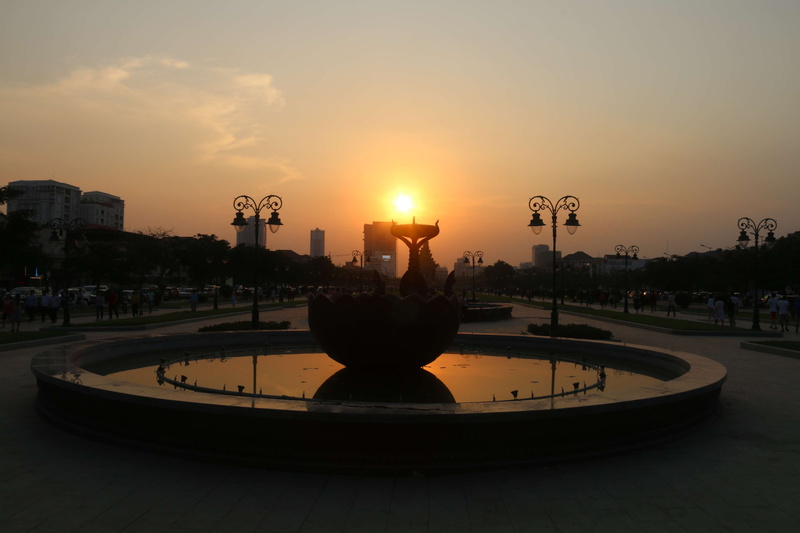 sculpture, sunlight, outdoors, building exterior, sunset, 4K, built structure, transportation, orange color, architecture, city, nature, fountain, street