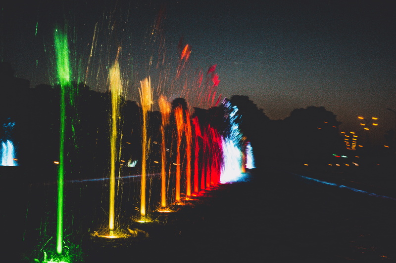 building exterior, blue, orange, water, minimalism, lights, fountain, built structure, nature, colorful, outdoors, yellow, illuminated, motion, glowing
