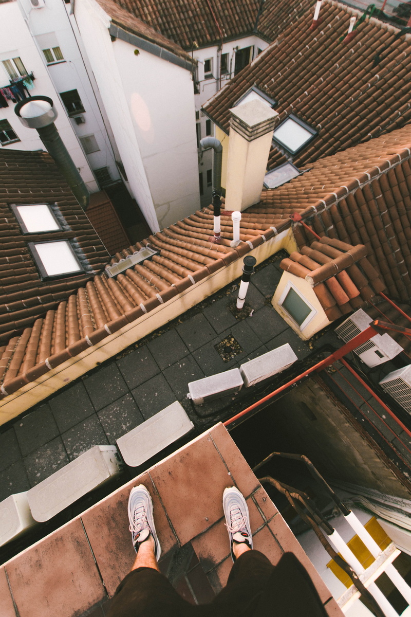lifestyles, incidental people, air max 97, cityscape, standing, human foot, real people, rooftop, rooftopping, leisure activity, high angle view, building