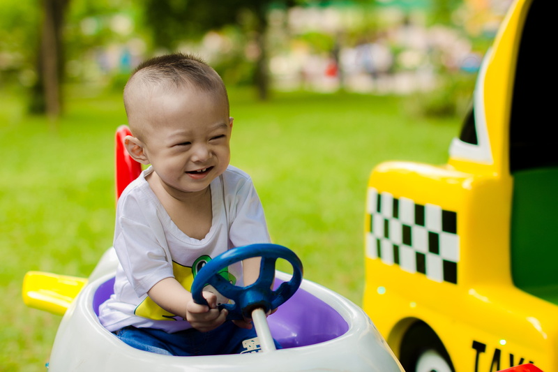 boys, outdoors, smiling, casual clothing, focus on foreground, nature, one person, males, boy, happiness, grass, day, park, child, playground, preschool age
