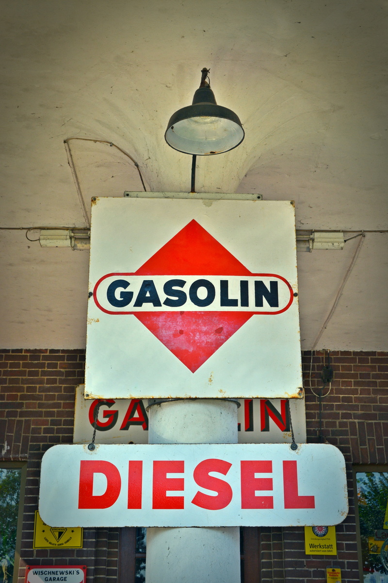 5K, outdoors, lighting equipment, architecture, capital letter, built structure, shield, old advertising, symbol, advertising sign, text, close-up, arrow symbol