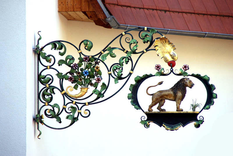 flower, animal representation, nature, wall - building feature, floral pattern, day, sideboard, green, no people, art and craft, iron, inn, plant, symbol