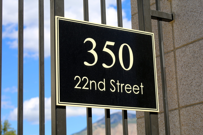 message, signage, building exterior, low angle view, hanging, nd, gate, no people, 350, glass - material, white, address, reflection, close-up, street