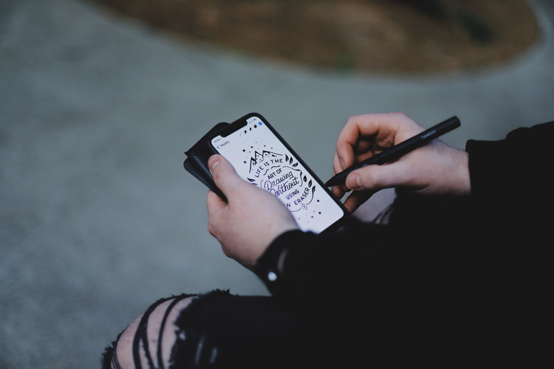 mobile phone, outdoors, person, space, dark, human body part, technology, communication, real people, wacom, one person, x, holding, hand lettering, portable information device