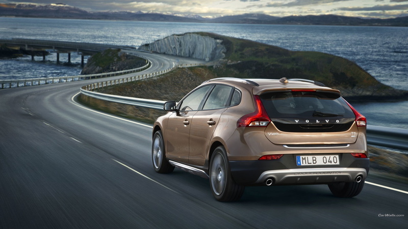 bridge - man made structure, transportation, coupe, day, sea, city, road, motion, architecture, bridge, Volvo V40, highway, road trip, colored, land vehicle