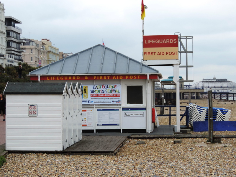 building, sign, east sussex, flag, western script, built structure, coastline, no people, sky, lifeguard, building exterior, nature, information sign, text