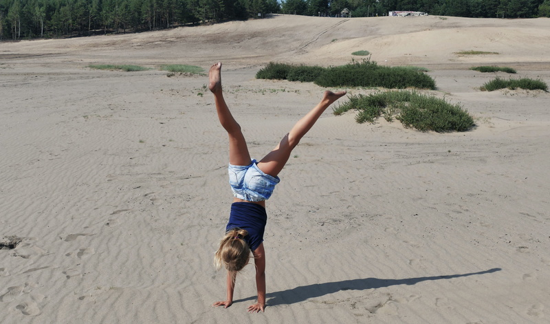 day, the rivalry, exercise, beach, futbol, full length, solution, effort, shorts, one person, real people, sand, upside down, casual clothing, sunlight