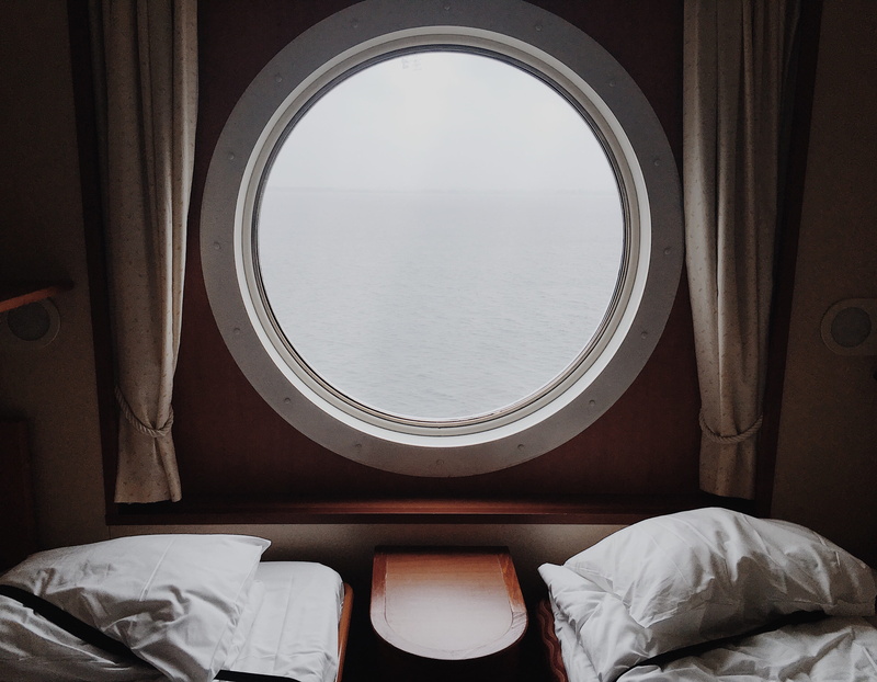 seat, glass - material, pillow, clear, indoors, pillows, no people, textile, curtain, pane, mirror, absence, day, white, furniture, boat bedroom, window