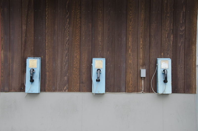 no people, choice, vintage, coin operated, blue, building, payphones, indoors, safety, old, wall - building feature, connection, security, technology, wood - material