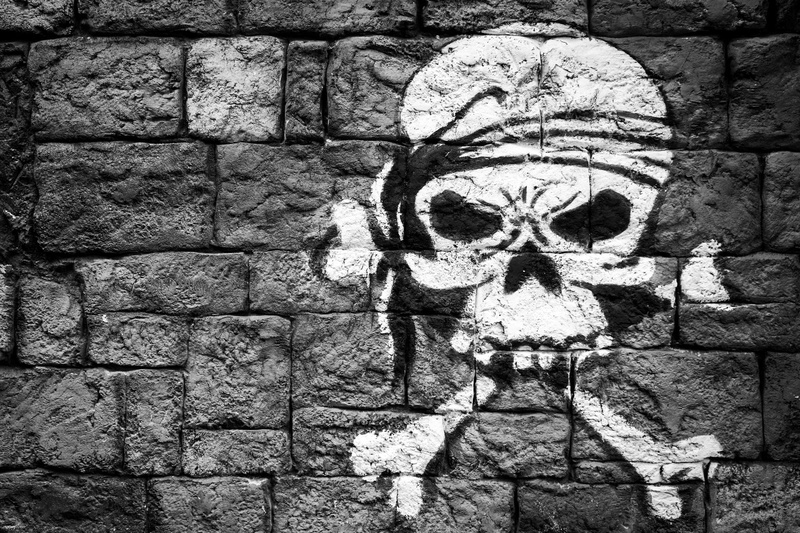 built structure, graffiti, close-up, human representation, stone wall, human skeleton, outdoors, wall - building feature, skull, pattern, architecture