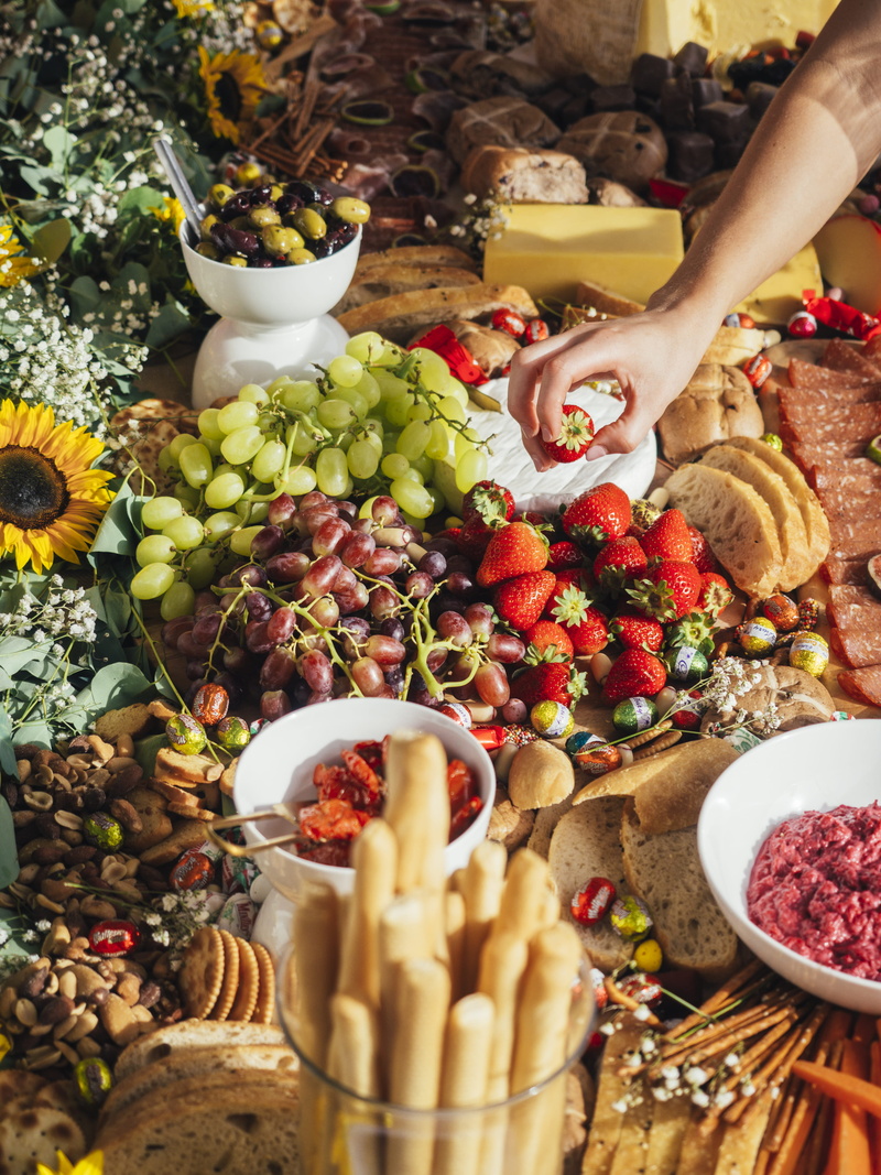real people, fruits, bright, bowl, grazing table, strawberry, human body part, cheese, pastries, wellbeing, freshness, holding, happiness, one person, variation