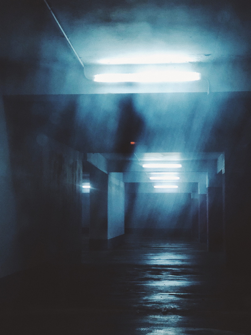 direction, floor, empty, ceiling, sign, subway, lighting equipment, hazy, dark, dungeon, blue, parking, architecture, fluorescent light, illuminated, scary