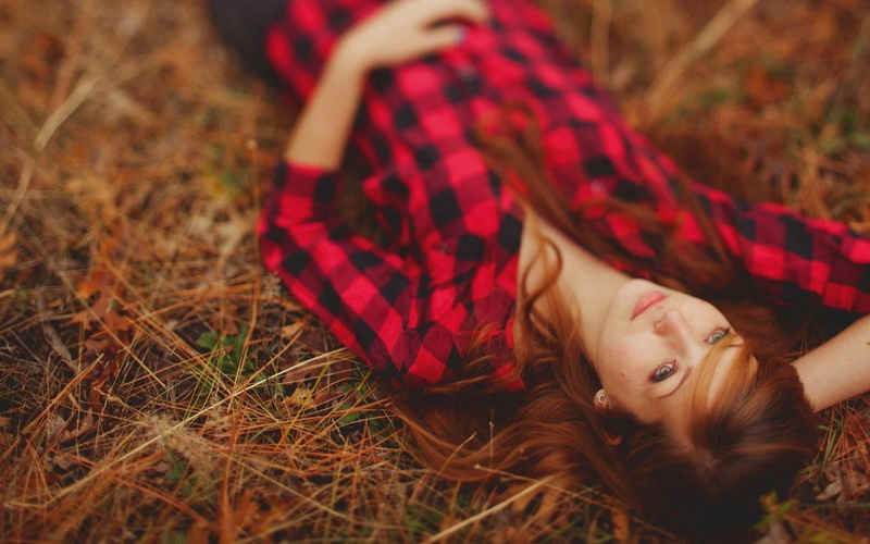 child, land, smiling, plaid shirt, teenager, contemplation, relaxation, plaid, emotion, one person, beautiful people, adult, hairstyle, redhead, lying on back