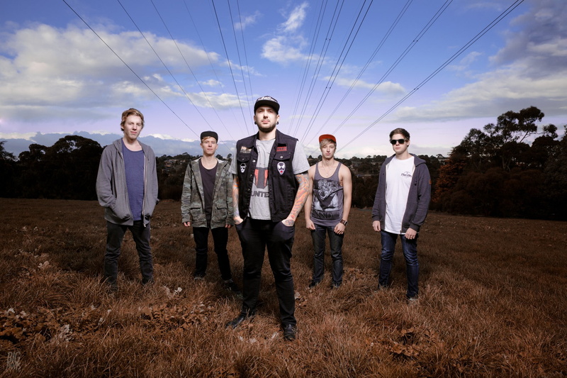 mature men, looking at camera, smiling, field, front view, musician, landscape, land, males, metal music, power lines, standing, cloud - sky, portrait