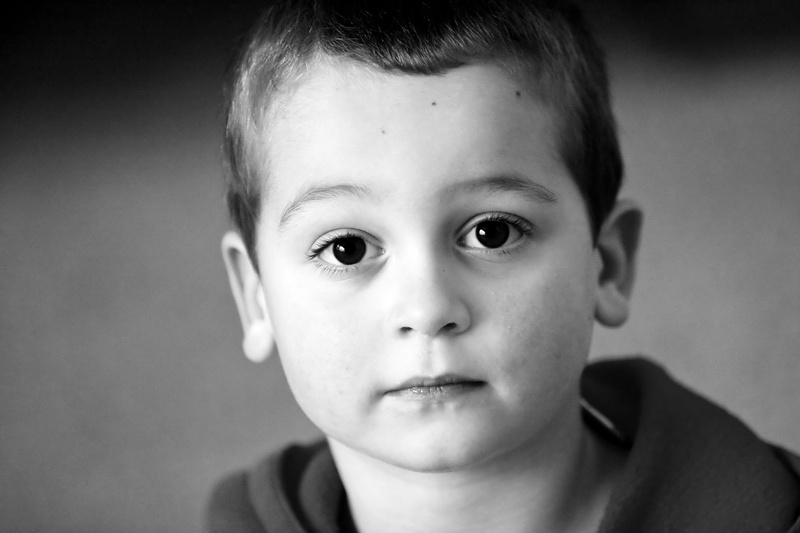 indoors, headshot, grayscale, kid, boy, photography, men, one person, looking at camera, offspring, males, big eyes, cute, body part, expression, portrait