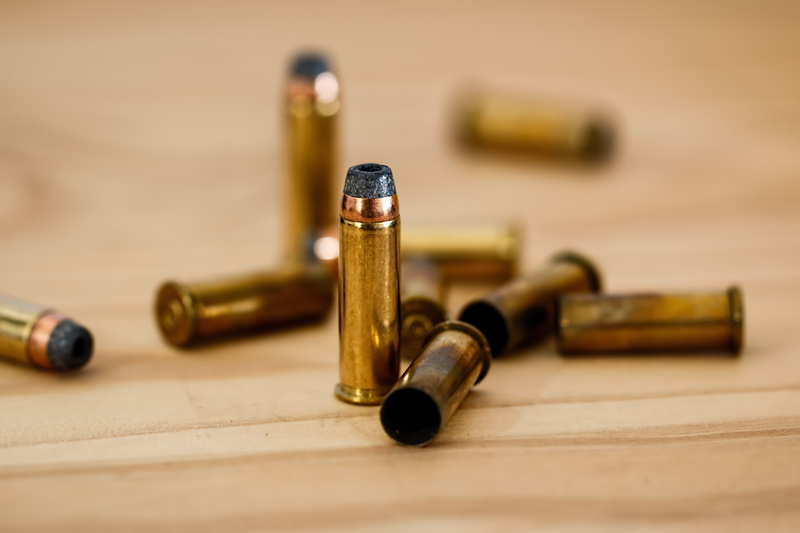 crime scene, carpentry, work tool, shell, bullet, metal, ammo, ammunition, round, crime, shooting, table, gun, selective focus, focus on foreground, defense