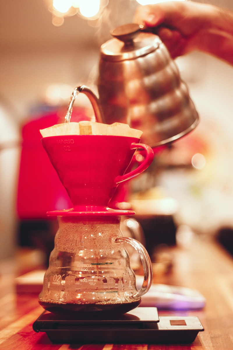 human body part, coffee pot, freshness, pouring, focus on foreground, human hand, red, preparation, brazil, cafe preto, water, one person, indoors, food