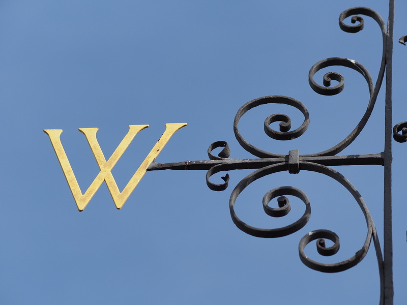 gate, cardinal, west, w, message, sky, shape, low angle view, outdoors, directional sign, communication, direction, metal, text, nature, wrought iron, wind vane