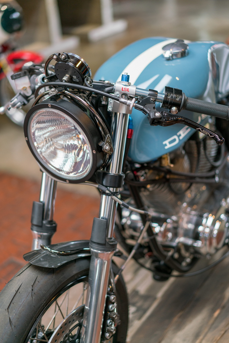 motorcycle, street, 8K, focus on foreground, architecture, front view, city, mode of transportation, handle, chrome, no people, metal, outdoors, united states