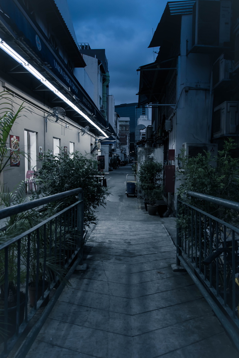 sky, street, back alley, city, dark, diminishing perspective, building exterior, no people, vertical, quiet, 4K, footpath, transportation, railing, outdoors