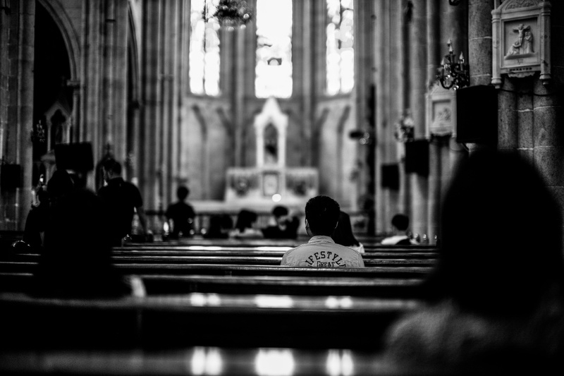 spirituality, altar, alleyway, dark, praying, incidental people, selective focus, street, adult, human, silhouette, cathedral, pew, indoor, grayscale, rear view