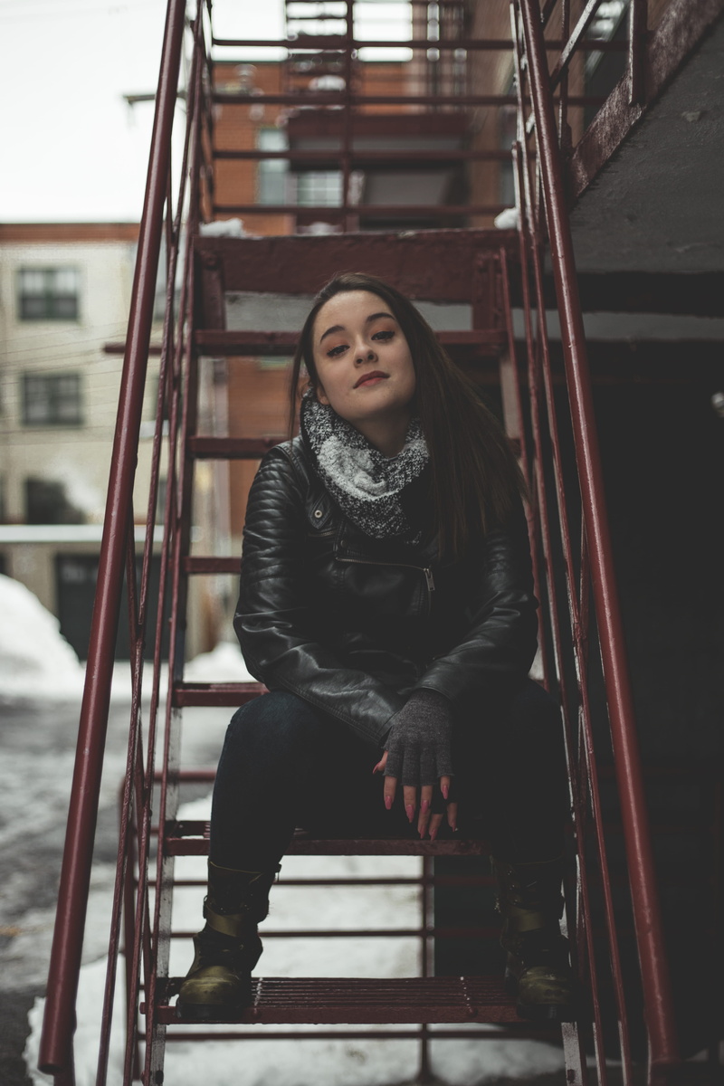 jeans, warm clothing, ladder, snow, city, looking at camera, long hair, red, leather, beautiful woman, portrait, stairs, architecture, style, casual clothing