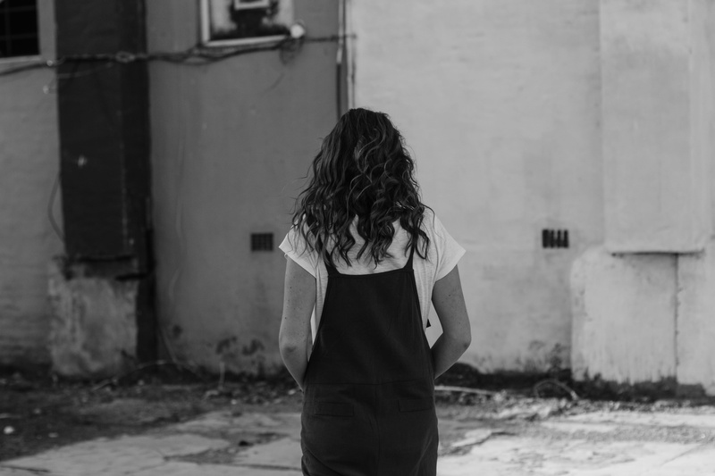 female, urban, wall, building exterior, near, built structure, rear view, casual clothing, clothing, human, outdoors, wall - building feature, alleyway