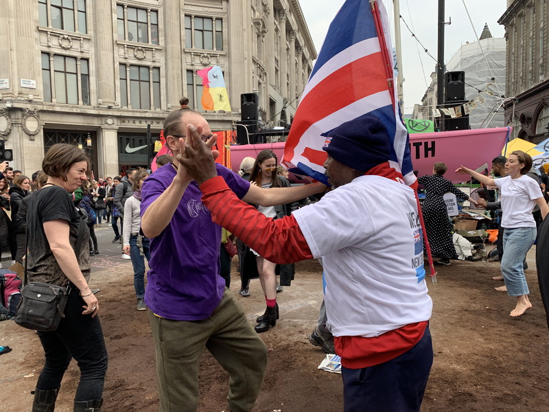 united kingdom, flag, large group of people, oxford circus, lifestyles, shoe, protestor, men, building exterior, street, dance, day, leisure activity, architecture
