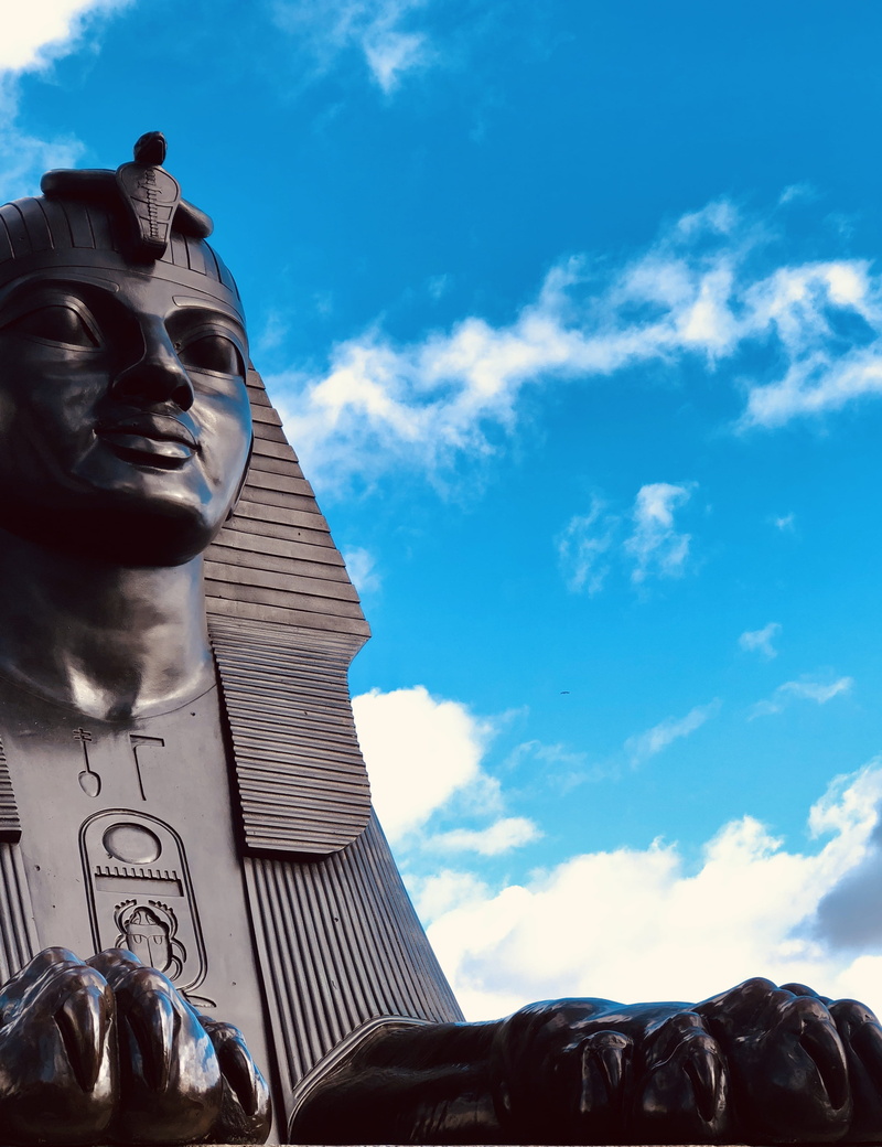creativity, monument, clothing, statue, apparel, pillar, urban, face, cloud - sky, religion, column, helmet, male likeness, craft, sky, town, blue, architecture