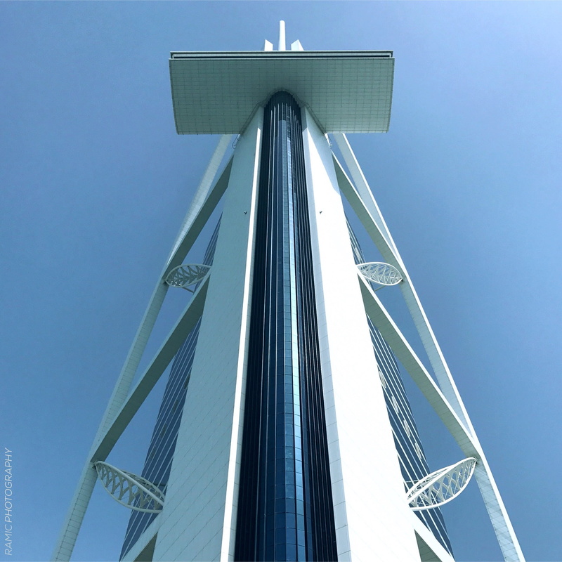 building, building exterior, dubai, blue, skyscraper, outdoors, office building exterior, modern, architecture, tower, low angle view, clear sky, hotel