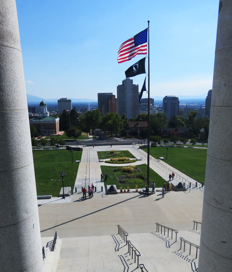 office building exterior, architectural column, flag, patriotism, government, incidental people, sunlight, travel, united states, nature, people, group of people