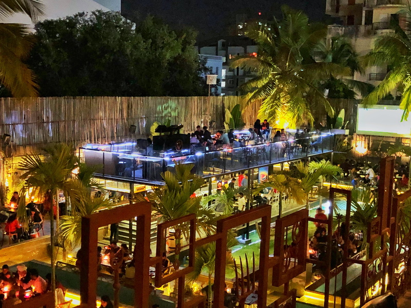 group of people, plant, building exterior, tropical climate, india, built structure, illuminated, 4K, water, tree, high angle view, nightlife, swimming pool