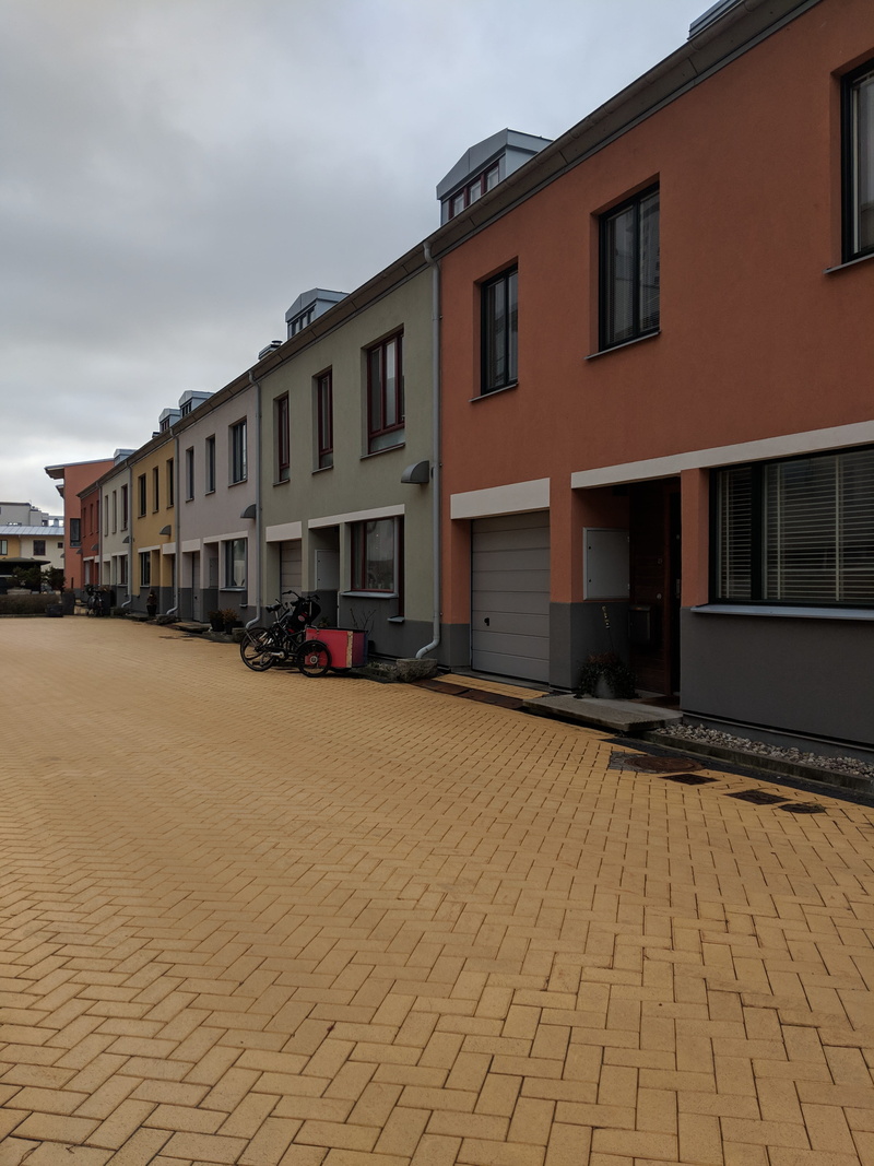 car, pastel colours, city, wheel, mode of transportation, outdoors, day, housing, nature, building exterior, no people, sidewalk, cobblestone, paving stone