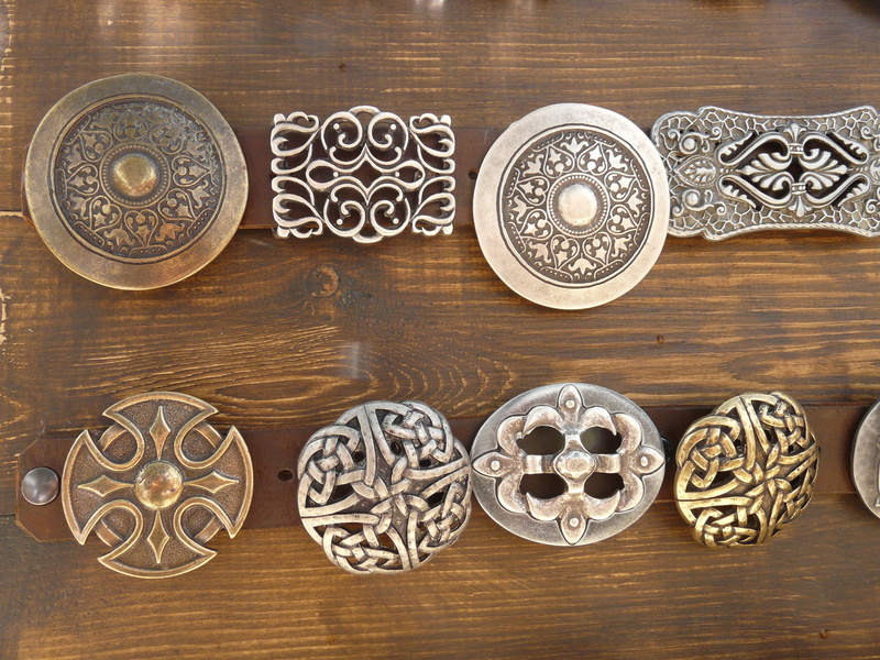 bowl, silver colored, table, decors, art and craft, belt buckles, high angle view, rosette, medium group of objects, emblem, wood - Material, colored, steel