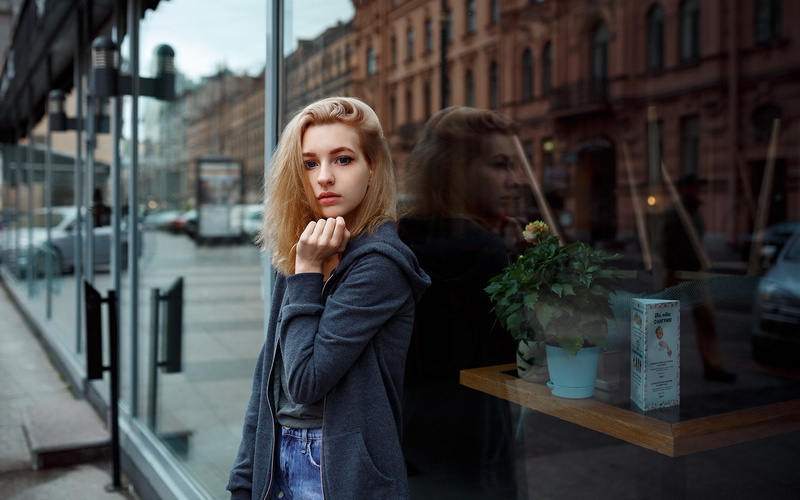 looking at viewer, Anastasia Sokol, warm clothing, sweatshirts, standing, young women, building exterior, model, waist up, real people, day, hair, architecture