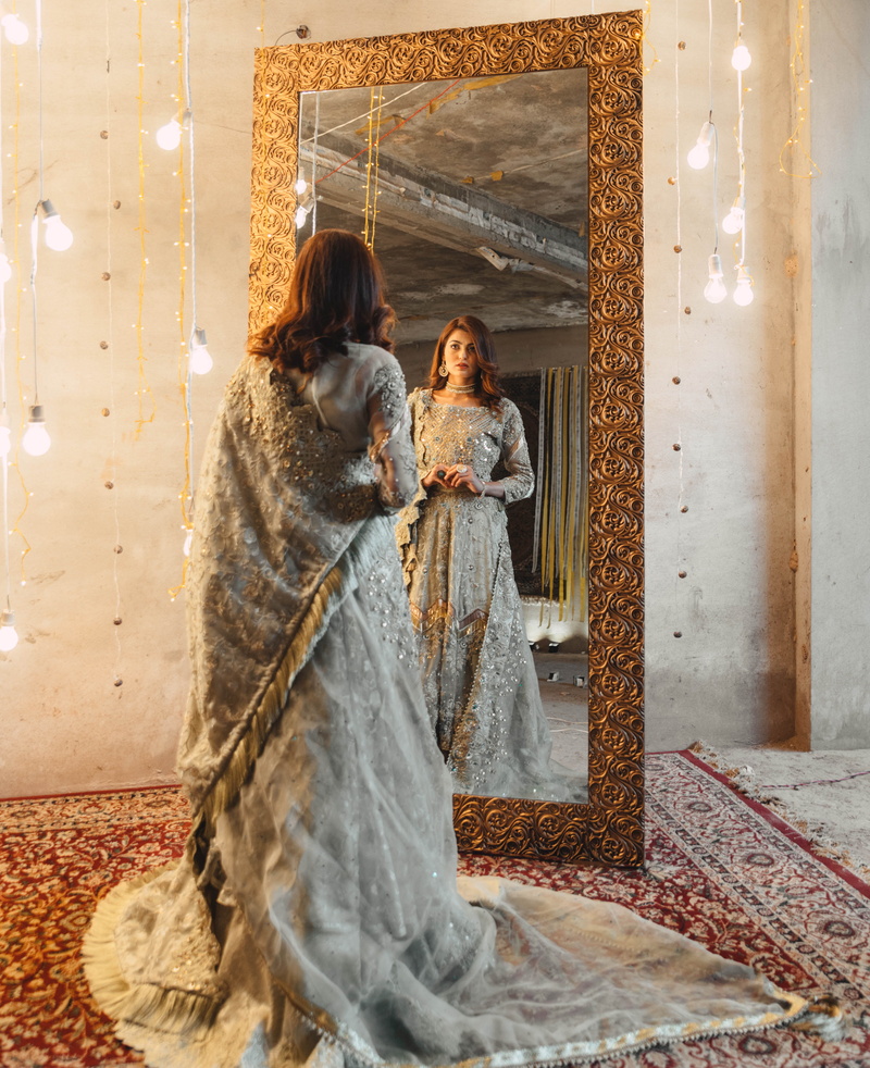 pakistan, fashion, happiness, women, real people, standing, smiling, warm clothing, dress, silver, adult, young women, beautiful, reflection, two people