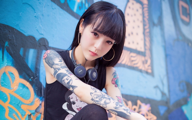 women, young adult, one person, lifestyles, Asian, fashion, hairstyle, graffiti, beautiful woman, real people, tattoo, leisure activity, bangs, sitting