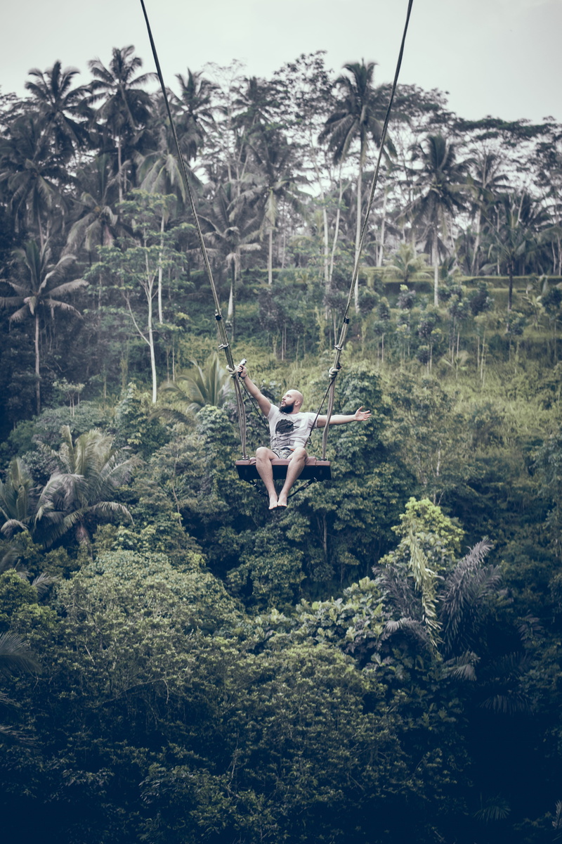 one person, jungle, swinging, daytime, women, plant, environment, altitude, hanging, grass, plants, lifestyles, sitting, leisure activity, real people