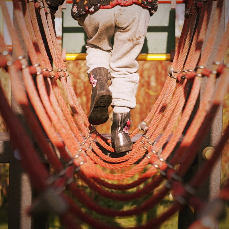 red, footwear, festival, sphere, low section, outside, focus on background, rust, day, selective focus, playing, hanging, outdoors, industry, occupation