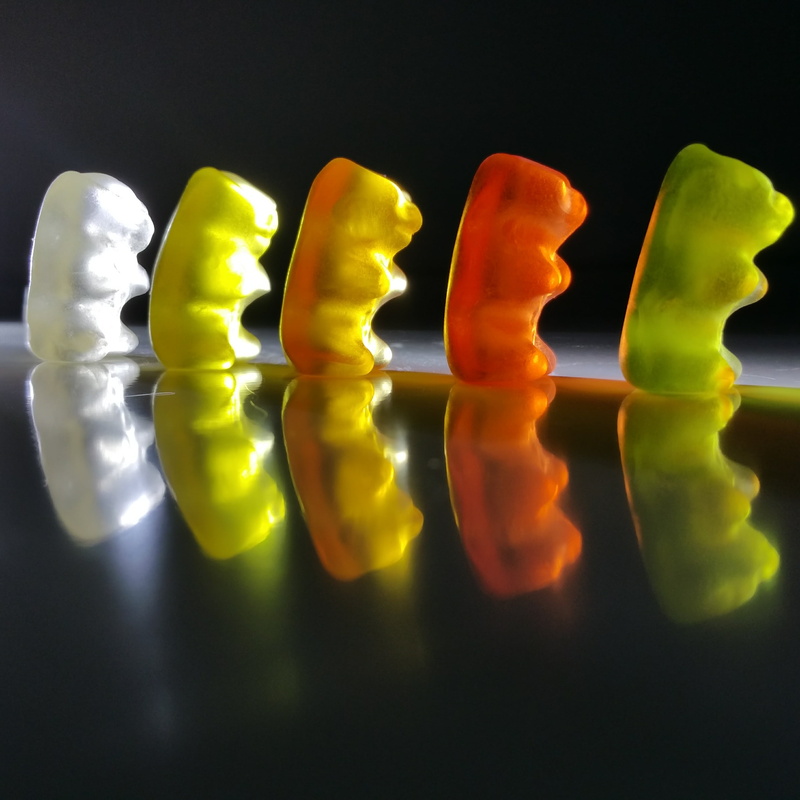 side by side, background image, sweet, indoors, no people, bear, multi colored, fruit jelly, gummi bears, temptation, studio shot, 2K, still life, in a row