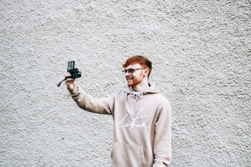 wall - building feature, architecture, person, photo, government, sleeve, wall, photographer, shooting a weapon, gun, taking, front, long sleeve, man, camera