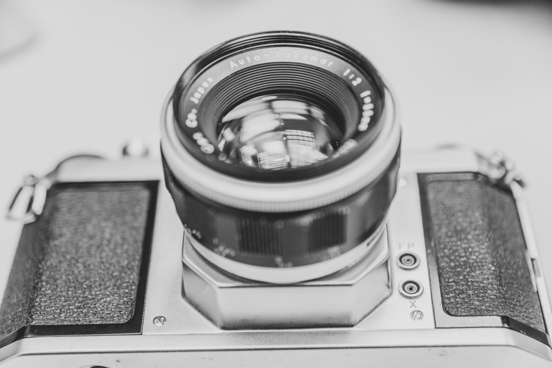 photographic equipment, retro styled, close-up, equipment, high angle view, railing, alloy wheel, no people, machinery, still life, metal, camera lens